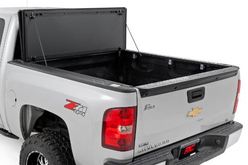 Flush, low-profile design with stylish matte black finish frame and aluminum panels. Tri-Fold 3 panel design allows full bed access. Corrosion resistant black powder coated aluminum frame. Secure track and rail mounting system with drain tubes included. Quick-connect ball-in-socket prop rods secure the cover in the fully open position. Nylon straps secure the cover in the 2/3 open position. Drive with the cover in the fully open, 2/3 open or closed position. Auto latching design secures on closure. Convenient one hand operation squeeze latches release. No drill easy install and removal - all tools included. Nylon safety straps included. 5 Year Warranty.