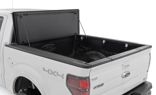 Flush, low-profile design with stylish matte black finish frame and aluminum panels. Tri-Fold 3 panel design allows full bed access. Corrosion resistant black powder coated aluminum frame. Secure track and rail mounting system with drain tubes included. Quick-connect ball-in-socket prop rods secure the cover in the fully open position. Nylon straps secure the cover in the 2/3 open position. Drive with the cover in the fully open, 2/3 open or closed position. Auto latching design secures on closure. Convenient one hand operation squeeze latches release. No drill easy install and removal - all tools included. Nylon safety straps included. 5 Year Warranty.
