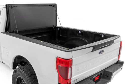 Flush, low-profile design with stylish matte black finish frame and aluminum panels. Tri-Fold 3 panel design allows full bed access. Corrosion resistant black powder coated aluminum frame. Secure track and rail mounting system with drain tubes included. Quick-connect ball-in-socket prop rods secure the cover in the fully open position. Nylon straps secure the cover in the 2/3 open position. Drive with the cover in the fully open, 2/3 open or closed position. Auto latching design secures on closure. Convenient one hand operation squeeze latches release. No drill easy install and removal - all tools included. Nylon safety straps included. 5 Year Warranty.