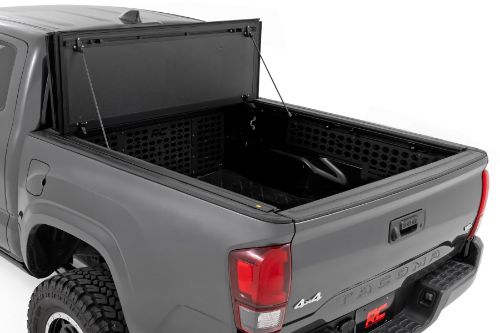 Flush, low-profile design with stylish matte black finish frame and aluminum panels. Tri-Fold 3 panel design allows full bed access. Corrosion resistant black powder coated aluminum frame. Secure track and rail mounting system with drain tubes included. Quick-connect ball-in-socket prop rods secure the cover in the fully open position. Nylon straps secure the cover in the 2/3 open position. Drive with the cover in the fully open, 2/3 open or closed position. Auto latching design secures on closure. Convenient one hand operation squeeze latches release. No drill easy install and removal - all tools included. Nylon safety straps included. 5 Year Warranty.