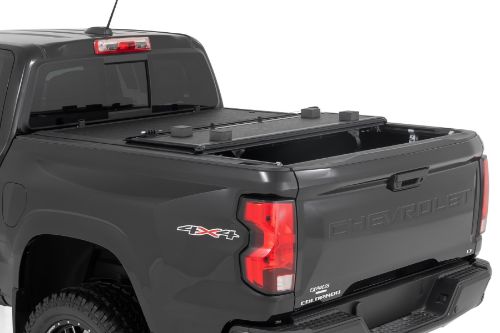 Flush, low-profile design with stylish matte black finish frame and aluminum panels. Tri-Fold Design allows quick access to cargo. Corrosion resistant black powder coated aluminum frame. Secure track and rail mounting system with drain tubes included. Nylon straps secure the cover in the 2/3 open position. Drive with the cover in the 2/3 open or closed position. Auto latching design secures on closure. Single cable pull for easy latch release and access. No drill easy install and removal - all tools included. Nylon safety straps included. 5 Year Warranty.