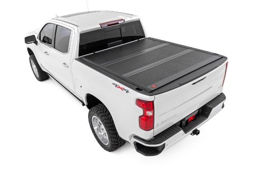 Flush, low-profile design with stylish matte black finish frame and aluminum panels. Tri-Fold Design allows quick access to cargo. Corrosion resistant black powder coated aluminum frame. Secure track and rail mounting system with drain tubes included. Nylon straps secure the cover in the 2/3 open position. Drive with the cover in the 2/3 open or closed position. Auto latching design secures on closure. Single cable pull for easy latch release and access. No drill easy install and removal - all tools included. Nylon safety straps included. 5 Year Warranty.