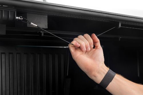 Flush, low-profile design with stylish matte black finish frame and aluminum panels. Tri-Fold Design allows quick access to cargo. Corrosion resistant black powder coated aluminum frame. Secure track and rail mounting system with drain tubes included. Nylon straps secure the cover in the 2/3 open position. Drive with the cover in the 2/3 open or closed position. Auto latching design secures on closure. Single cable pull for easy latch release and access. No drill easy install and removal - all tools included. Nylon safety straps included. 5 Year Warranty.