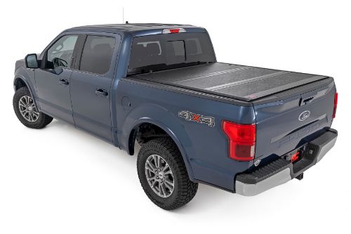 Flush, low-profile design with stylish matte black finish frame and aluminum panels. Tri-Fold Design allows quick access to cargo. Corrosion resistant black powder coated aluminum frame. Secure track and rail mounting system with drain tubes included. Nylon straps secure the cover in the 2/3 open position. Drive with the cover in the 2/3 open or closed position. Auto latching design secures on closure. Single cable pull for easy latch release and access. No drill easy install and removal - all tools included. Nylon safety straps included. 5 Year Warranty.