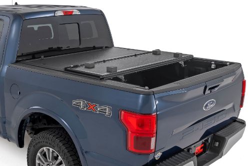 Flush, low-profile design with stylish matte black finish frame and aluminum panels. Tri-Fold Design allows quick access to cargo. Corrosion resistant black powder coated aluminum frame. Secure track and rail mounting system with drain tubes included. Nylon straps secure the cover in the 2/3 open position. Drive with the cover in the 2/3 open or closed position. Auto latching design secures on closure. Single cable pull for easy latch release and access. No drill easy install and removal - all tools included. Nylon safety straps included. 5 Year Warranty.