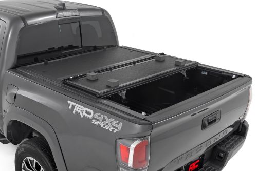 Flush, low-profile design with stylish matte black finish frame and aluminum panels. Tri-Fold Design allows quick access to cargo. Corrosion resistant black powder coated aluminum frame. Secure track and rail mounting system with drain tubes included. Nylon straps secure the cover in the 2/3 open position. Drive with the cover in the 2/3 open or closed position. Auto latching design secures on closure. Single cable pull for easy latch release and access. No drill easy install and removal - all tools included. Nylon safety straps included. 5 Year Warranty.