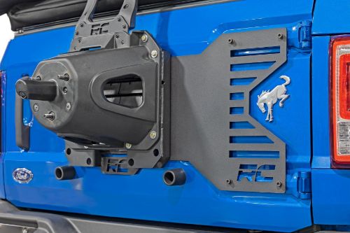 Reduces strain on swing-out tailgate. Allows for mounting of larger aftermarket tires and wheels. Evenly distributes weight across both hinges. Easy, bolt-on installation process. Durable, solid-steel construction. Powder coated black for a long lifespan of good looks. Works with factory and Rough Country Spare Tire Carriers.