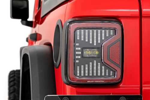 DOT and SAE approved. Enhances performance and appearance. Brighter than factory tail lights. IP67 Waterproof Housing. Heat Resistant Lens to prevent discoloring of lens. Functions as Factory Tail Lights: Turn Signal, Brake, Running, and Reverse Lights. Built-in Anti-flicker Load Resistor. Connects directly to the factory plug. No cutting or splicing of wires. Laser etch Rough Country logo.
